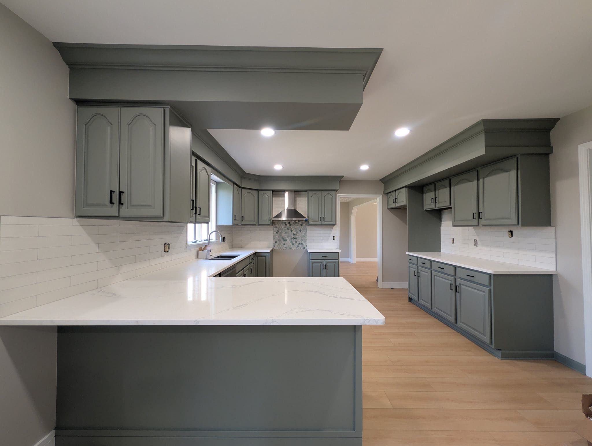 The full kitchen refinished in white and grey