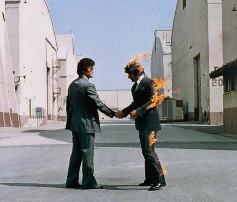 Wish You Were Here cover with two men shaking hands and one on fire