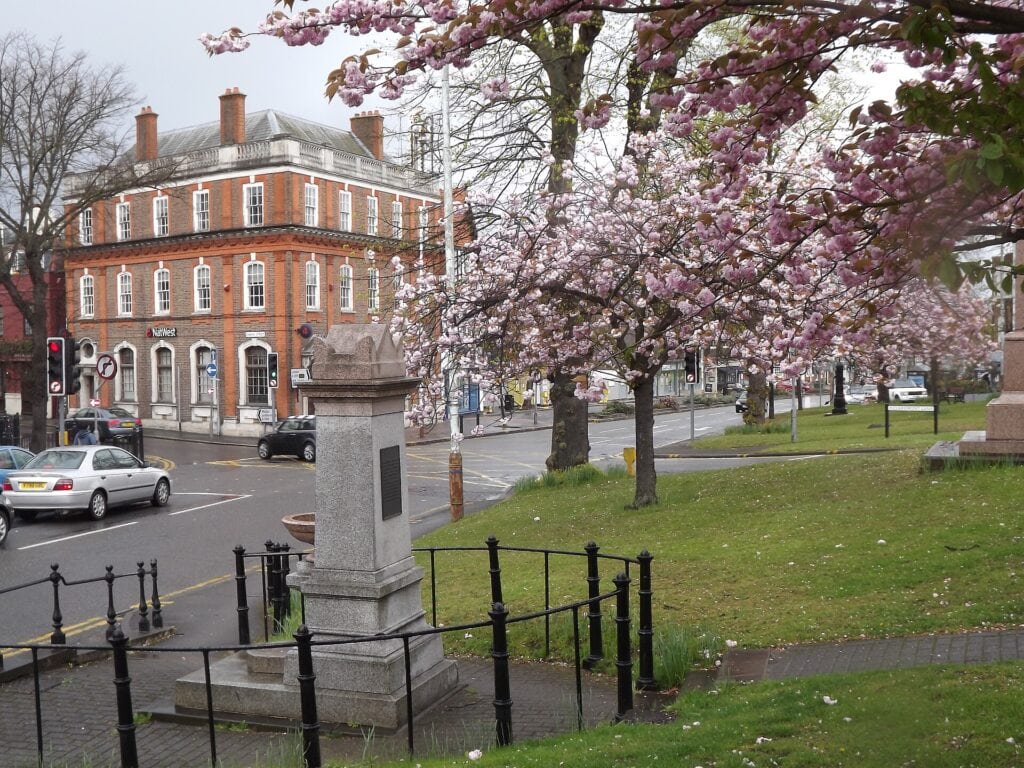 Esher town centre in spring, with cherry blossom on the green. Photo: Colin Smith, CC BY-SA 2.0