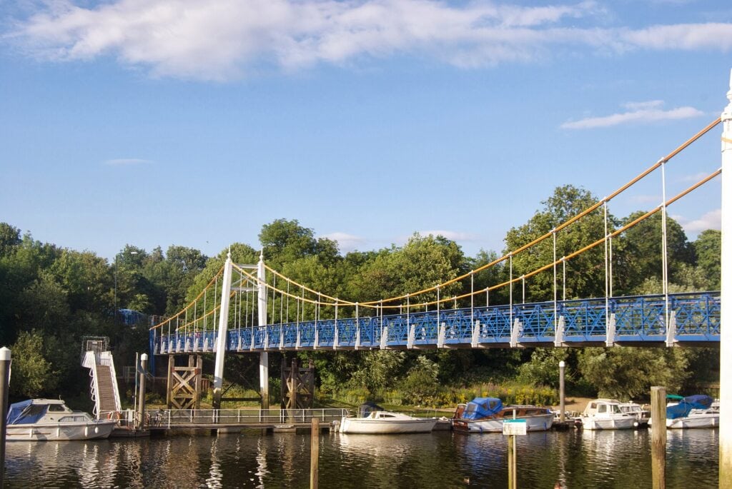 Teddington Lock footbridge over the Thames, with boats moored below