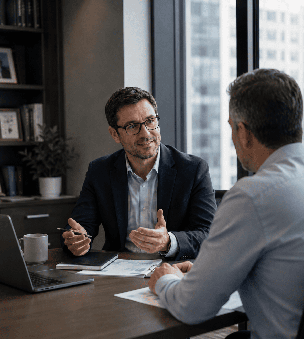 Independent insurance agent meeting with an advisor in a modern office