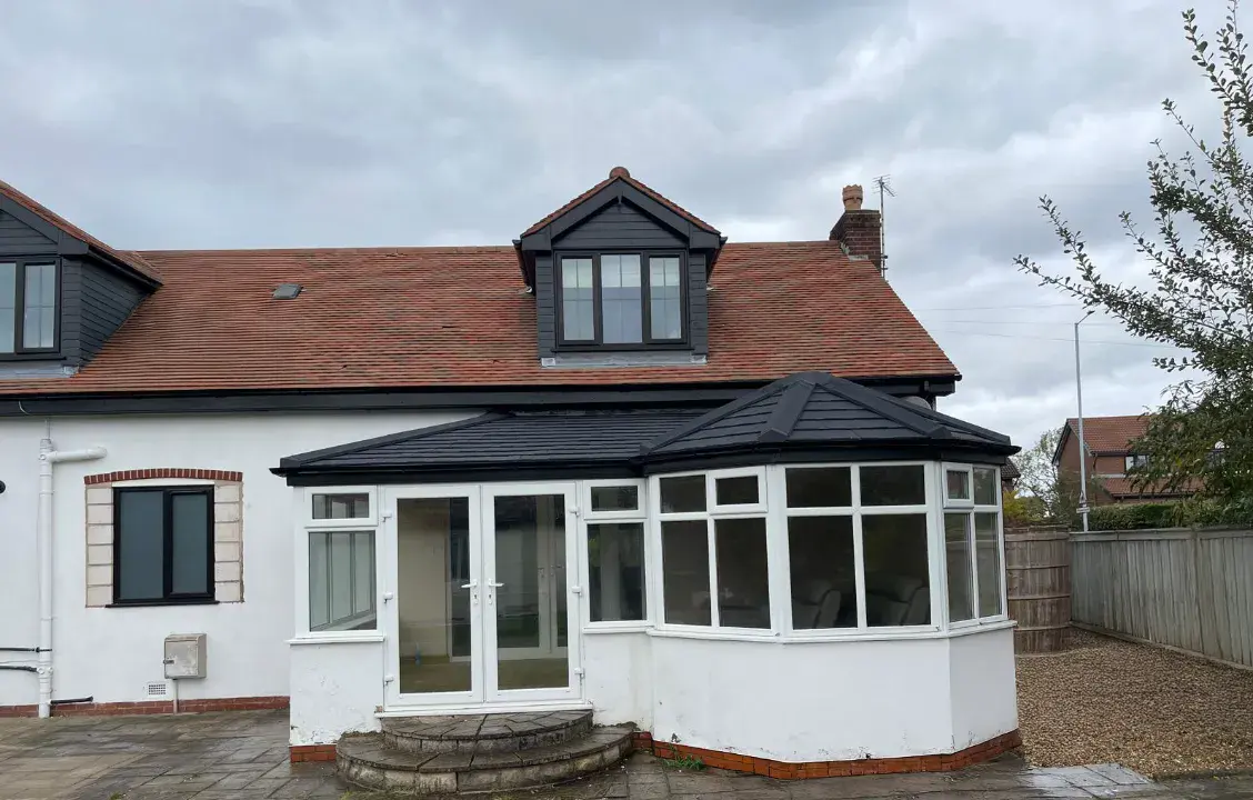 white conservatory with brick style rooftop