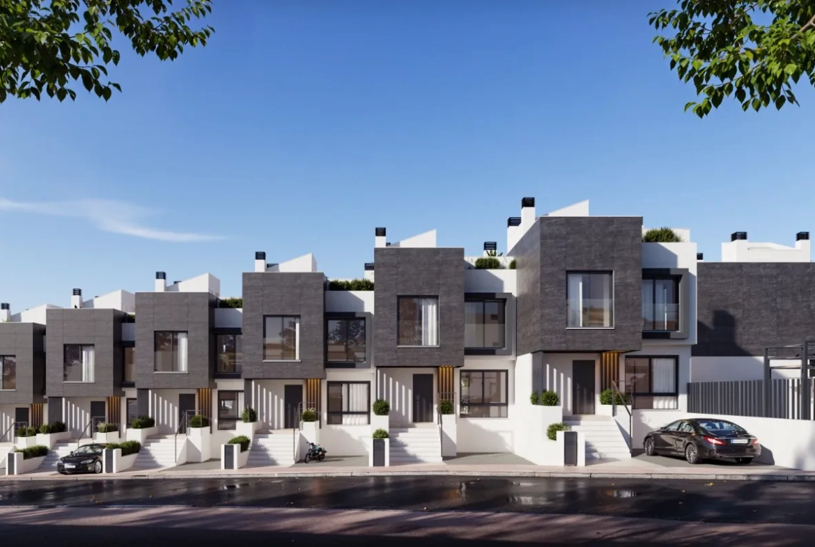 Celkový pohled na moderní rezidenční komplex ve Fuengirole s čistými liniemi a prosklenými balkony. V popředí se nachází prostorné venkovní parkoviště a krytá stání, což zajišťuje pohodlné a bezpečné parkování přímo u vstupu do budovy