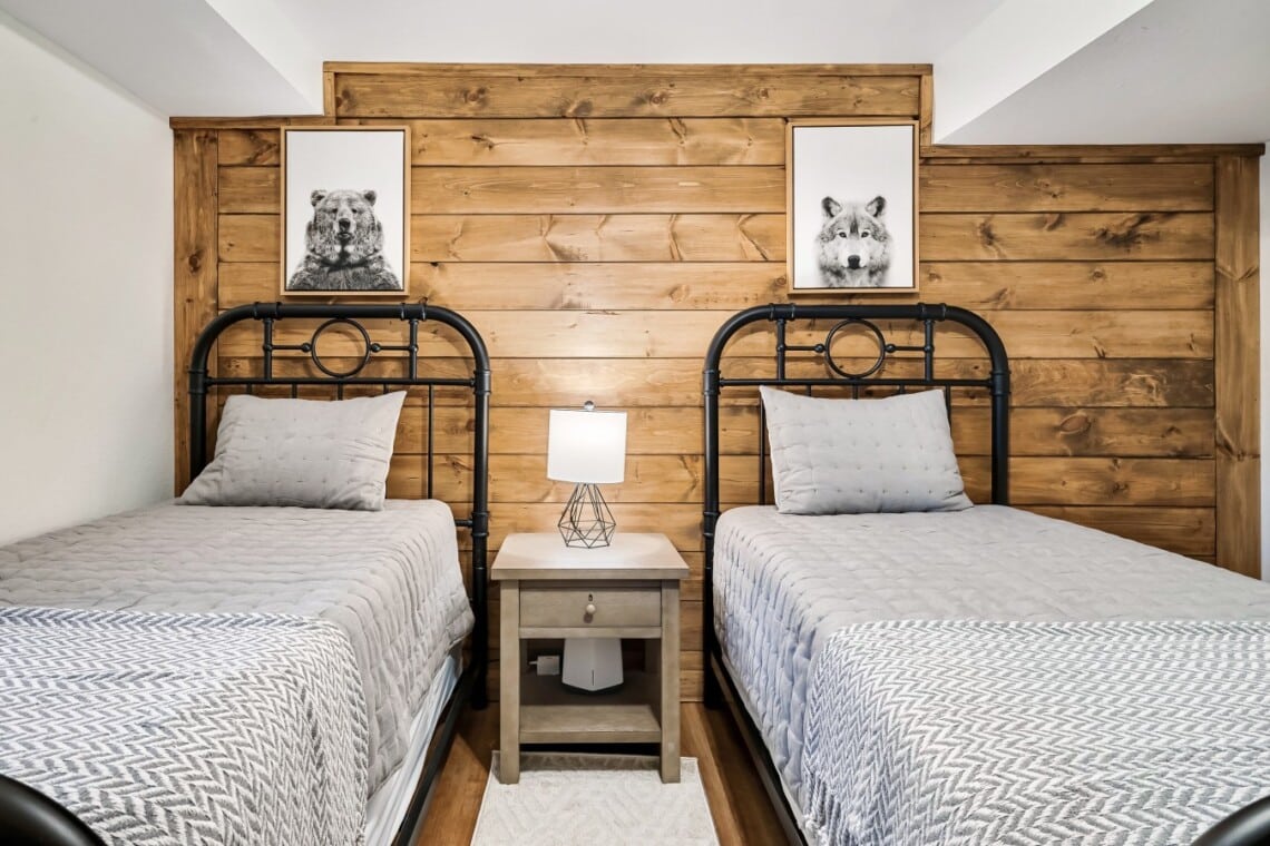 A cozy lower-level bedroom with twin beds and a 42 inch TV.