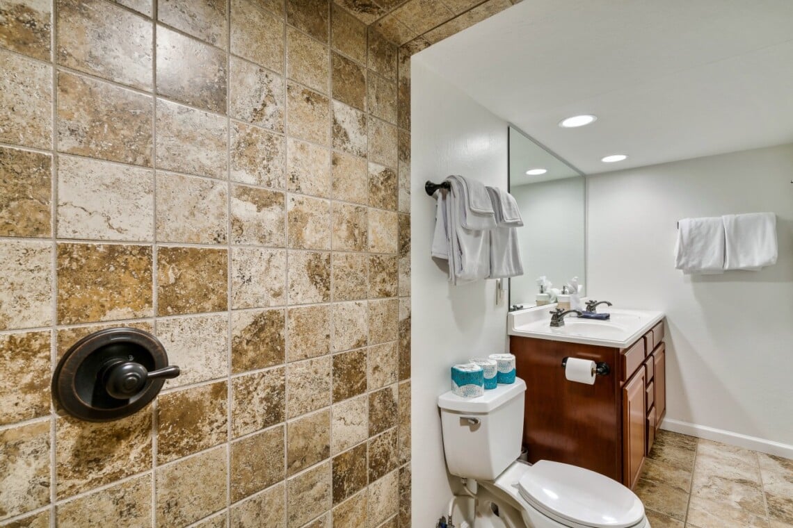 Lower-level bathroom with a dual vanity for extra convenience.