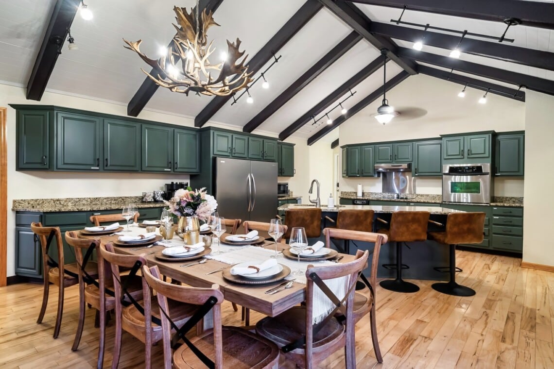 Spacious gourmet kitchen with dining table and counter seating, perfect for cooking and gathering.