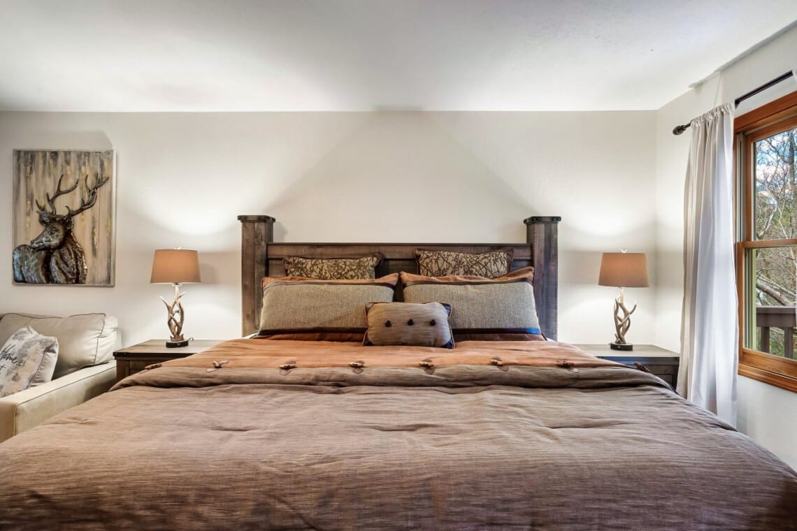 Spacious primary bedroom with en suite featuring an 42-inch TV for relaxing evenings.