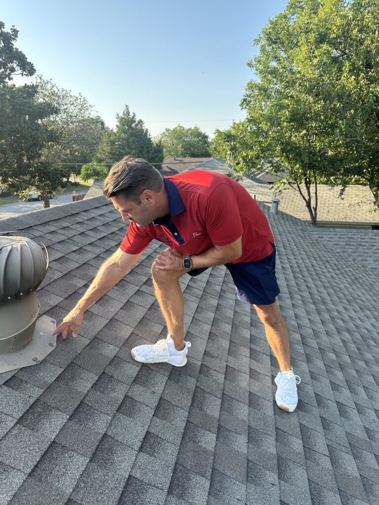 Elliott Smith, owner of Texan Roofworks, inspecting a shingle roof in DFW