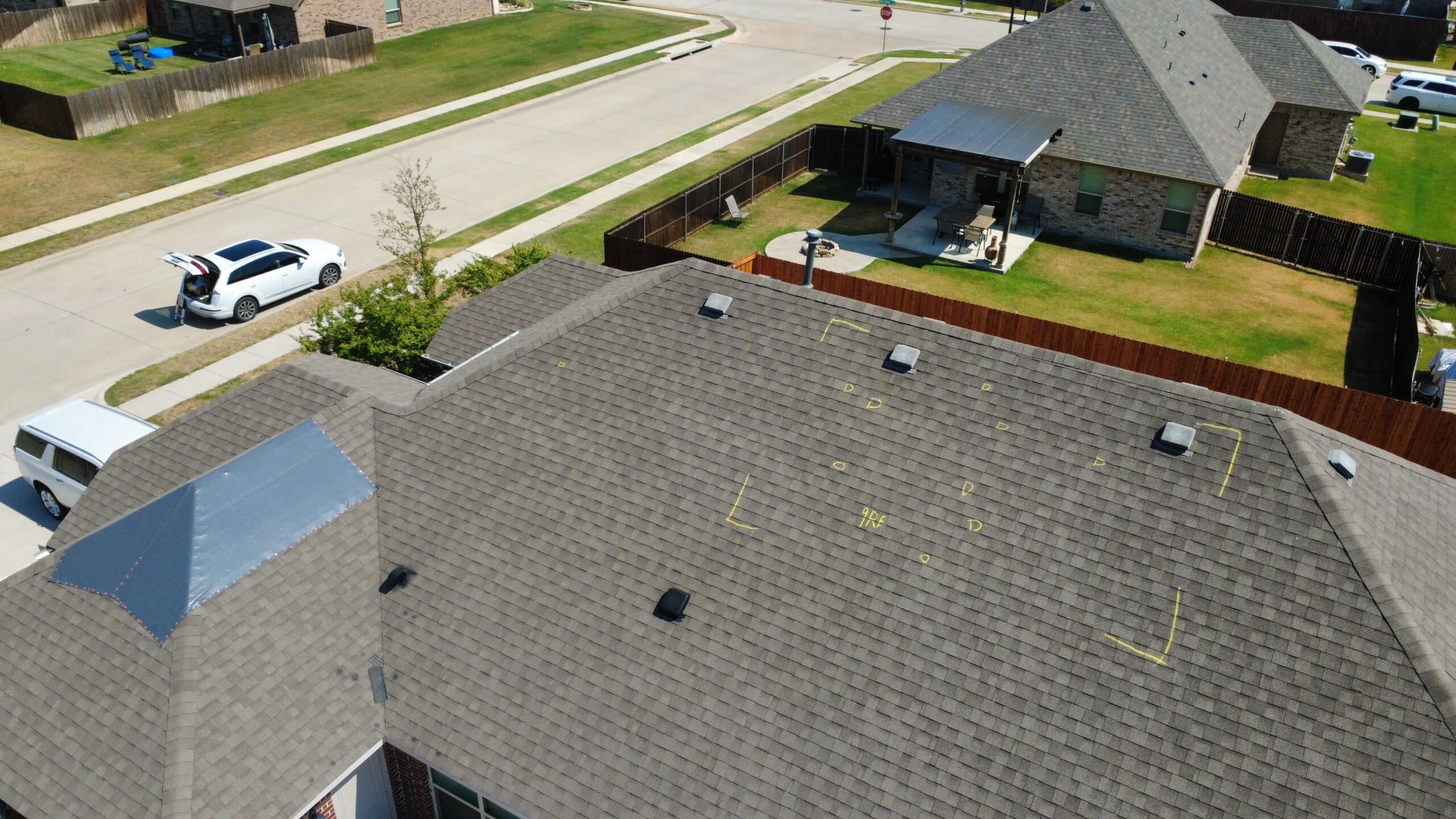 Aerial roof inspection showing marked asphalt shingles and roof penetrations in Krum Texas