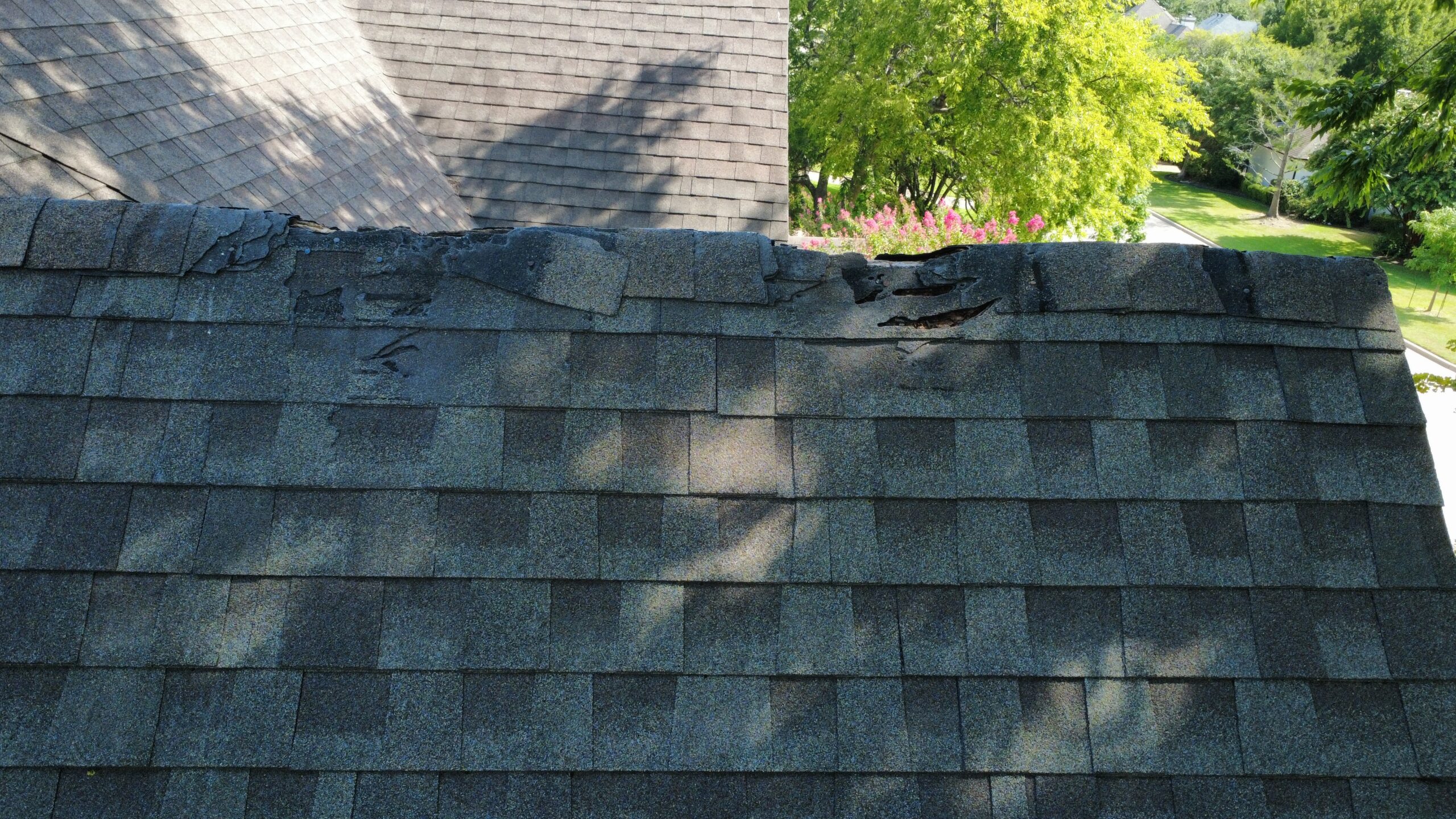 Deteriorated ridge-cap shingles documented during a Southlake roof repair inspection