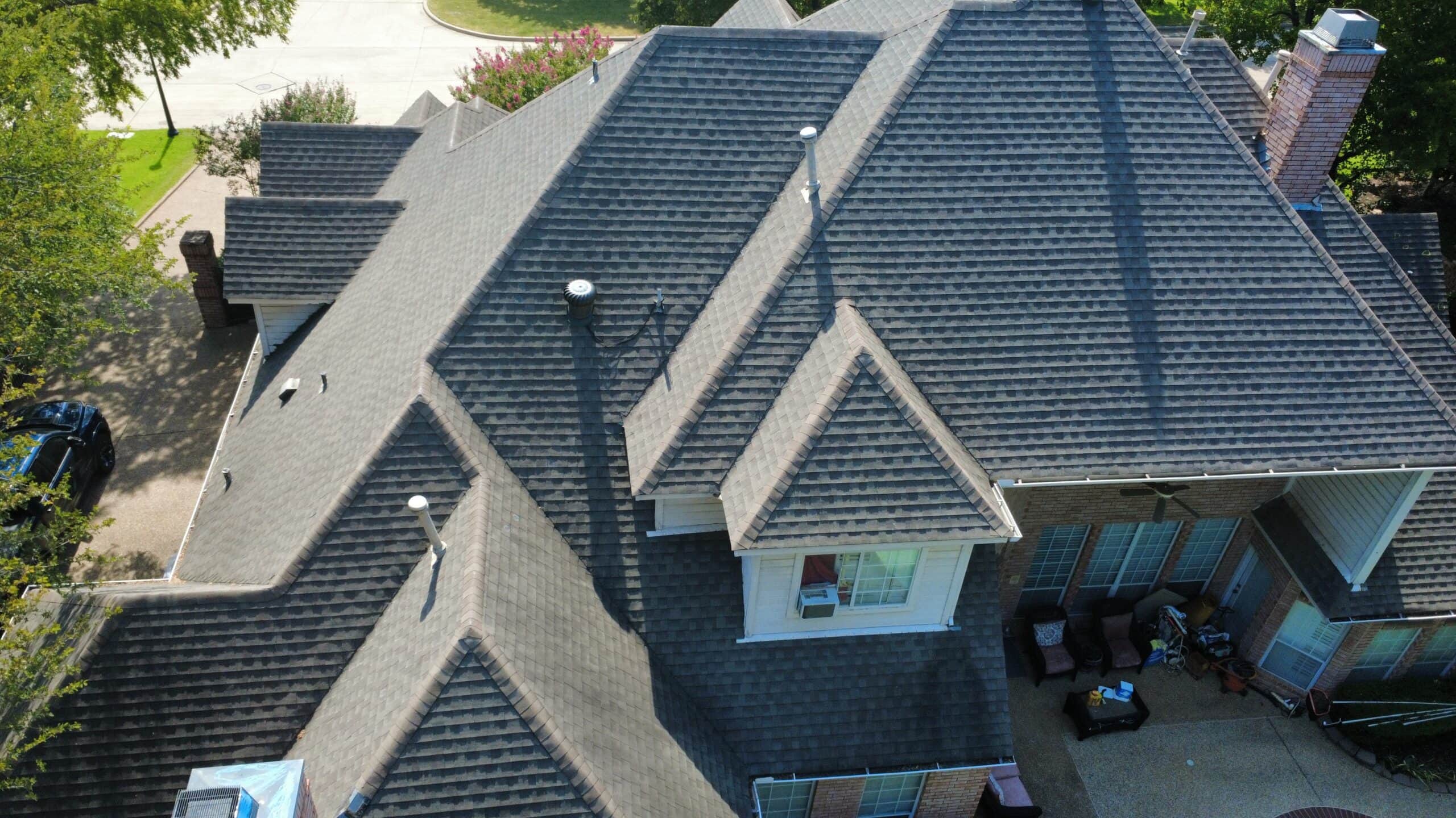 Aerial view of a complex asphalt-shingle roof inspected by Texan Roofworks in Southlake Texas