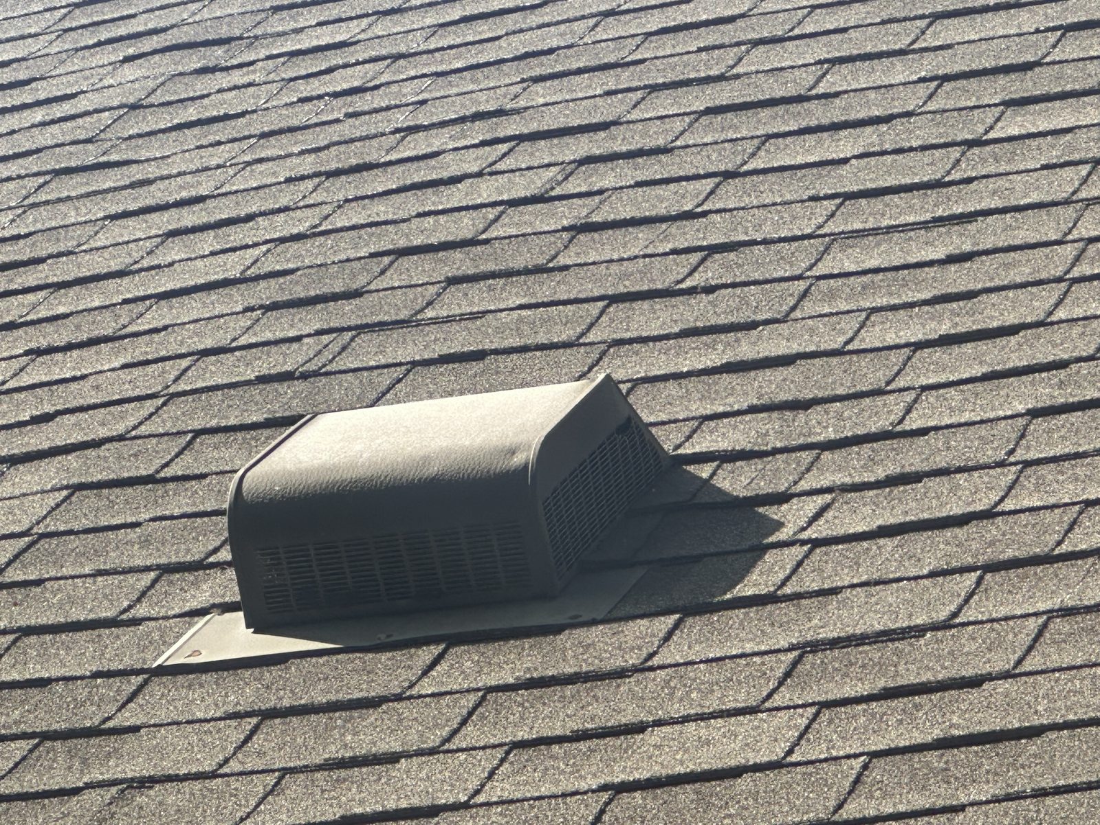 Asphalt shingle roof with roof vent feature visible.