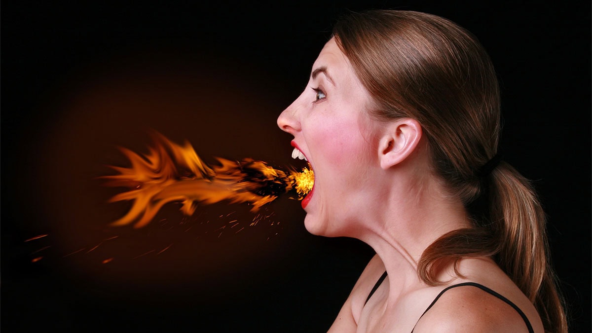 woman-with-long-brown-hair-dramatically-breathing-fire