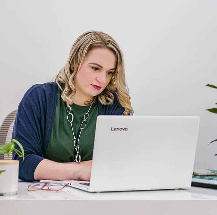 Adriana sitting at desk using laptop