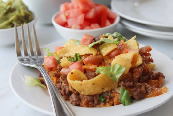 Looking for a simple easy weeknight dinner that the entire family can enjoy? You'll want to grab a bag of Fritos and try this easy and delicious Walking Taco Casserole!