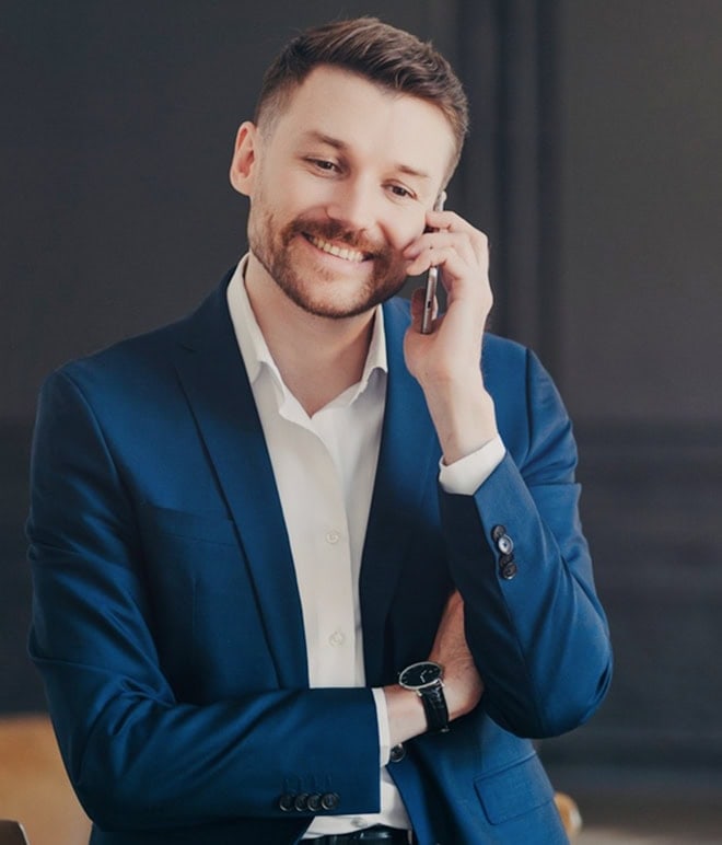 Efficient professional man in blue suit talking on phone for intelligent assistant services.