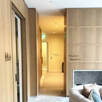 Through view of wayfinding signs within One Carrington Apartments