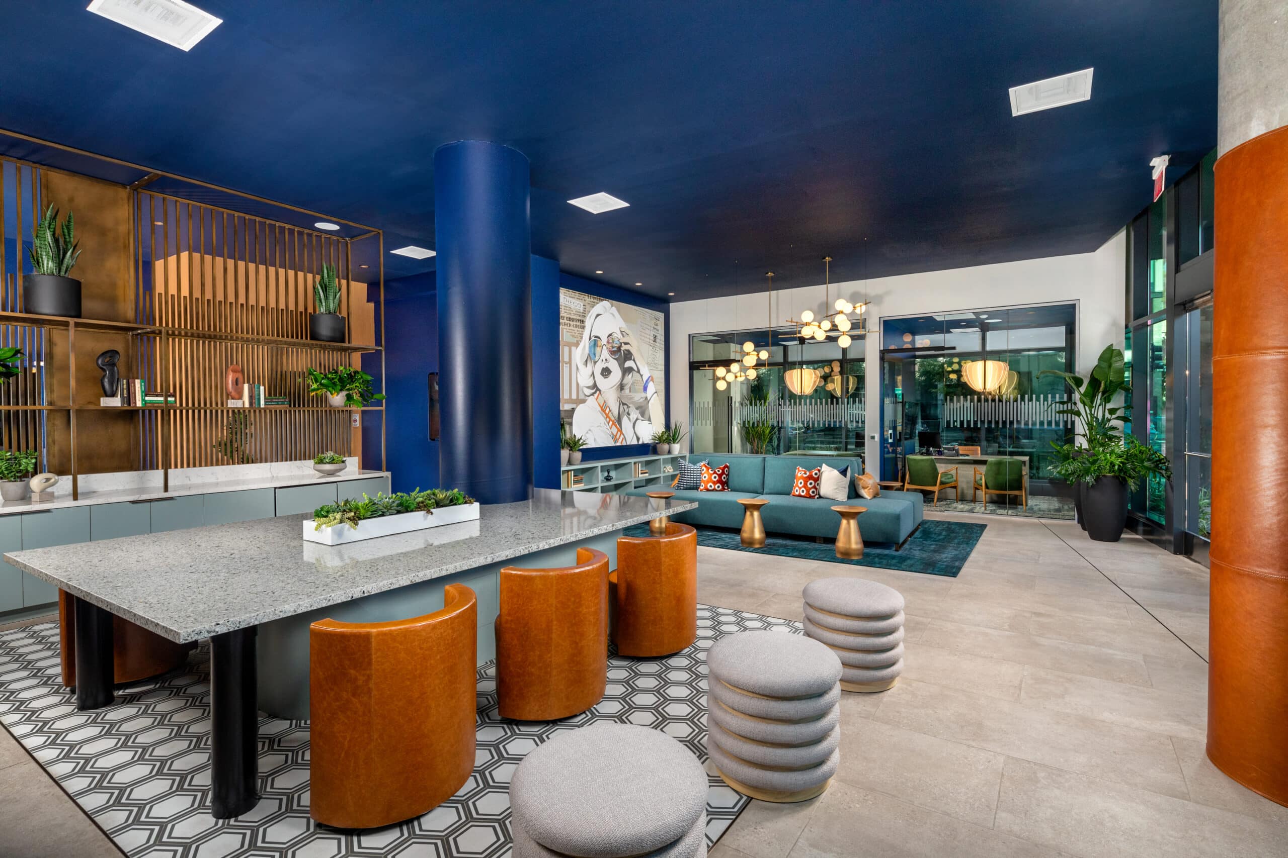A lobby with couches, tables, and chairs at The Wyatt new apartments in San Diego, CA.