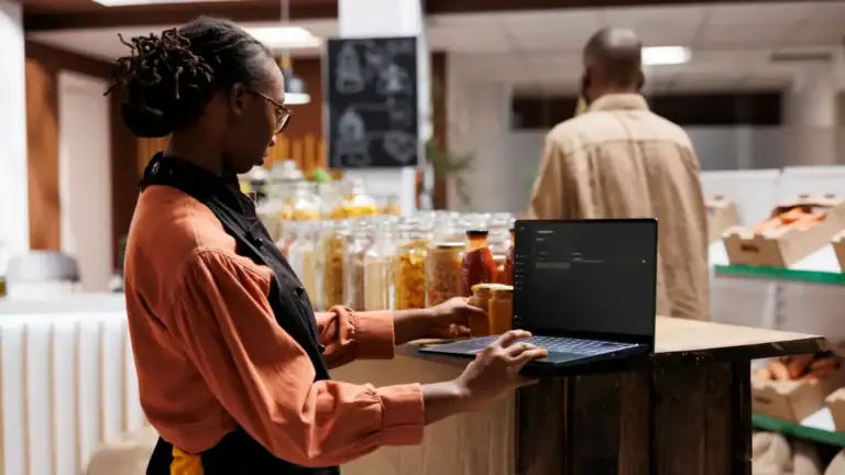 Store manager using ATLAS on a tablet at a retail counter to manage operations