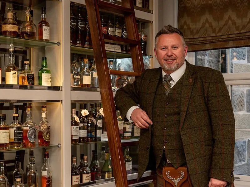 Tour guide in the Dowans hotel whisky snug on a Speyside whisky tour from Glasgow