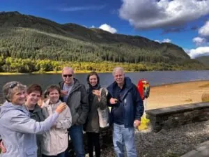 Some of our clients enjoying a dram of single malt whisky at Loch Lubnaig on our Stirling Castle & Trossachs Day tour at tourguidescotland.com
