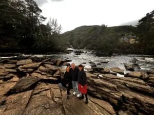 Some of our clients enjoying a visit to The Falls of Dochart on one of our 5 Day tours of Scotland at tourguidescotland.com