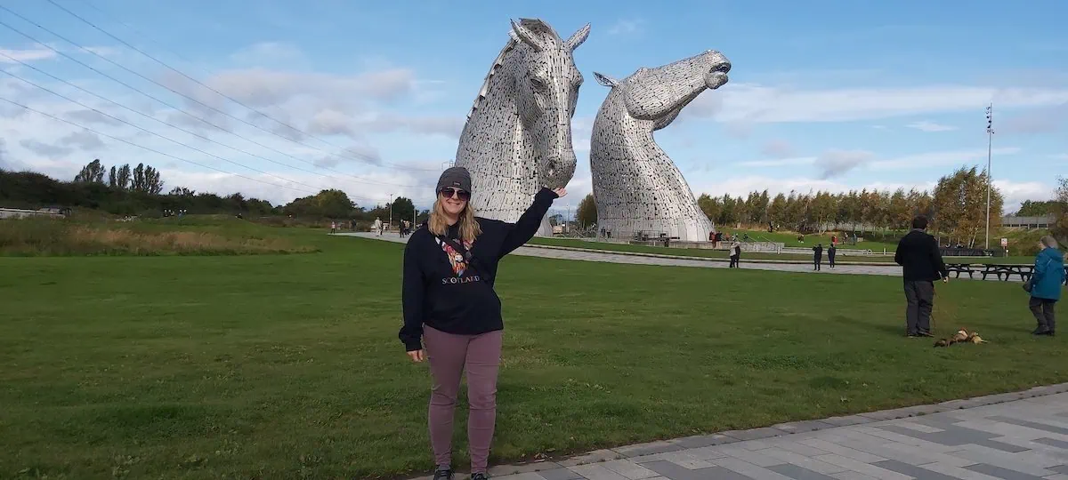 Tourist posing in front of Kelpies on our Falkirk Wheel & Kelpies Tour