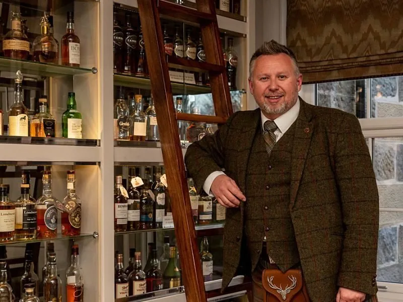 Tour guide in the Dowans hotel whisky snug on a Speyside whisky tour from Glasgow