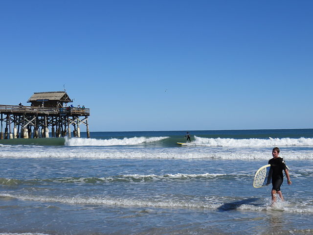 Family surfing near Cocoa Beach Pier on the Space Coast