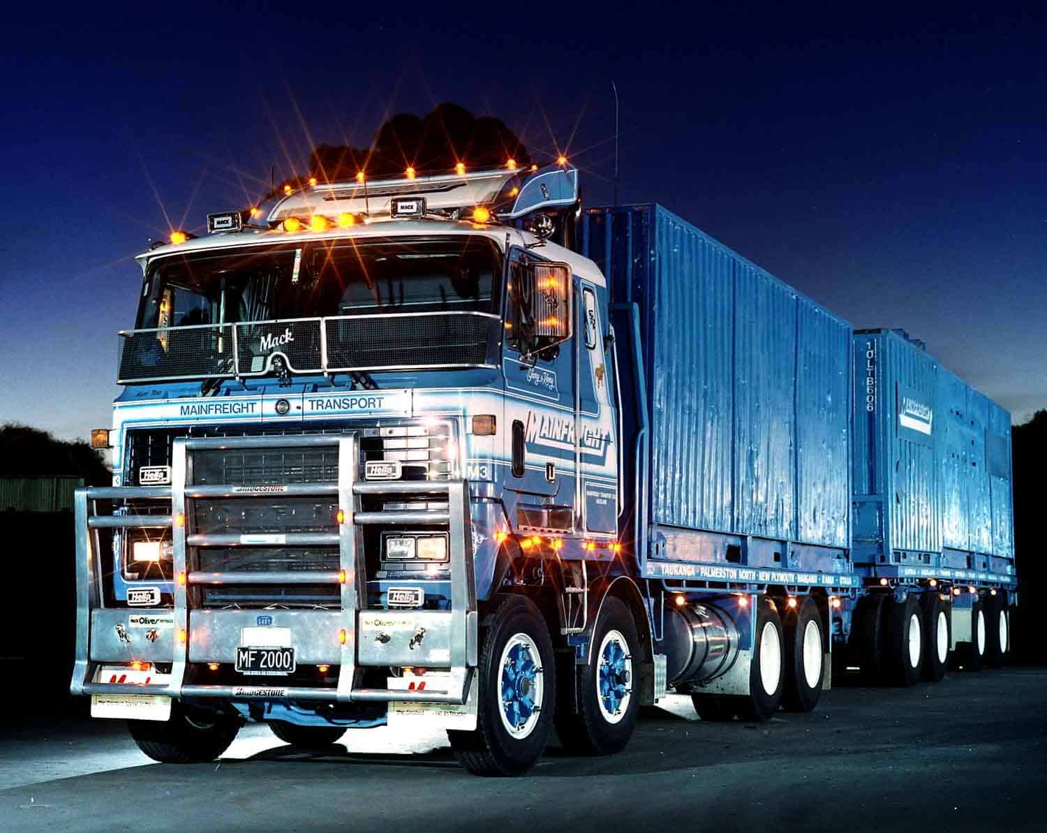 Heavy freight truck with containers at night, showcasing logistics and transportation services.
