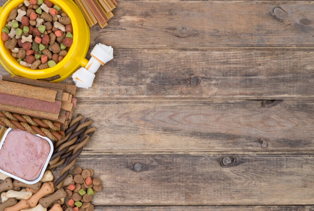 Pet food and treats on wooden surface.