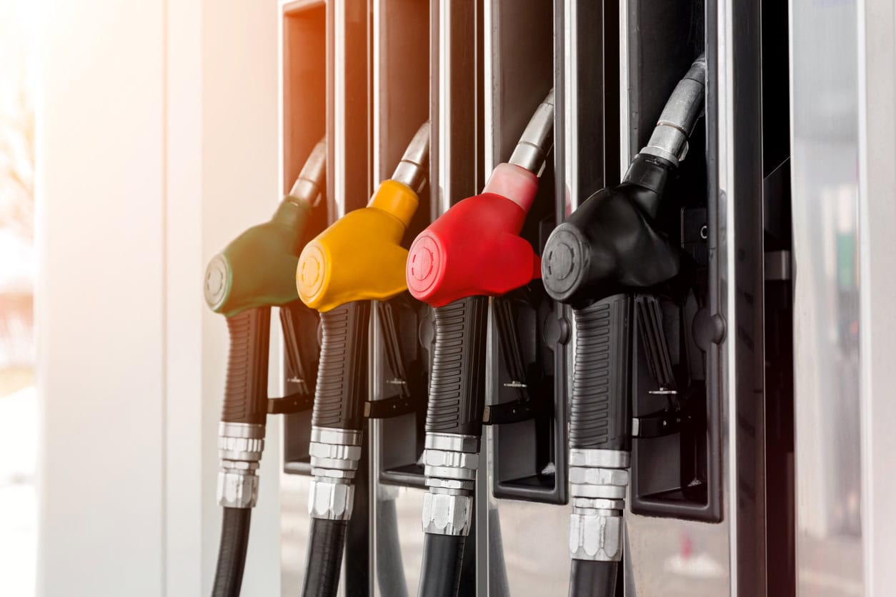 Fuel pump nozzles in various colors displayed.