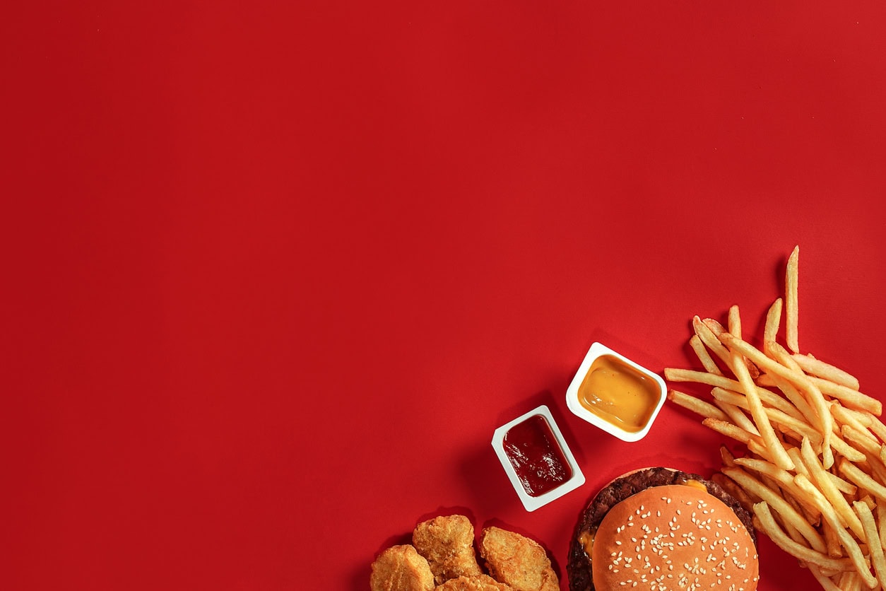 Fast food meal with fries and dipping sauces.