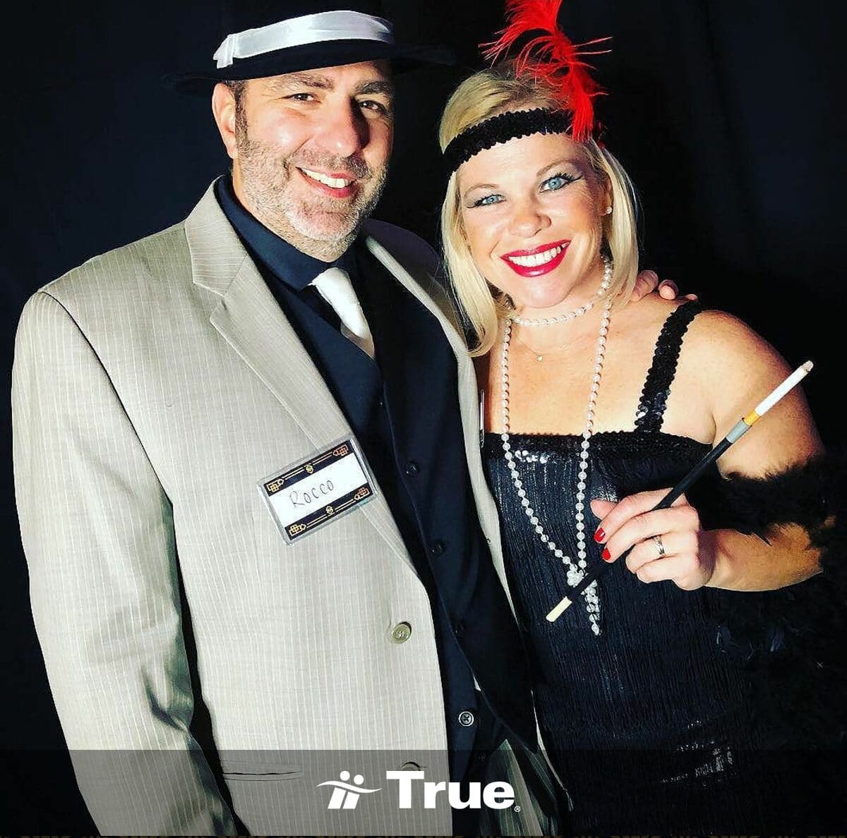 Couple dressed in vintage party attire.