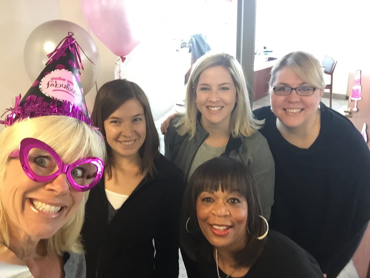 Group of women celebrating with festive accessories.