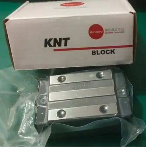 A close-up of an LM Guide showing the block and rail assembly