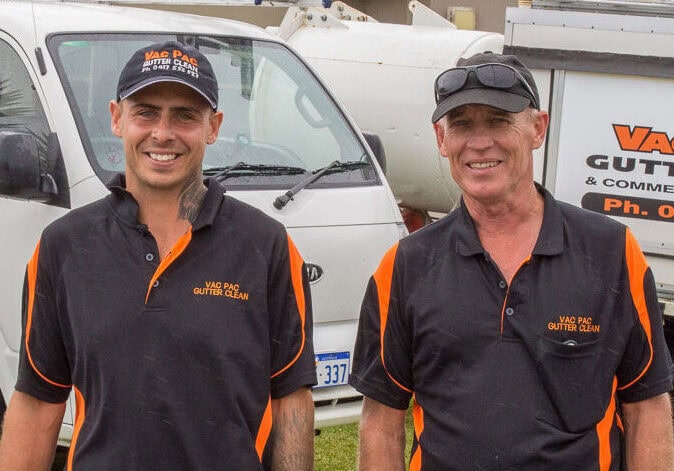 Gutter Cleaning Directors - Brad & Brodie with two gutter vacuum trucks.