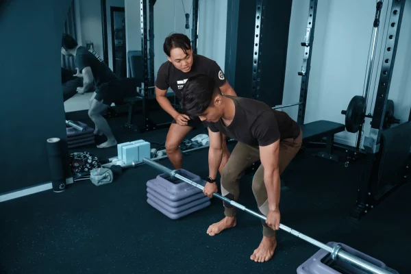 Victor coaching client deadlift, part of injury prevention and strength training