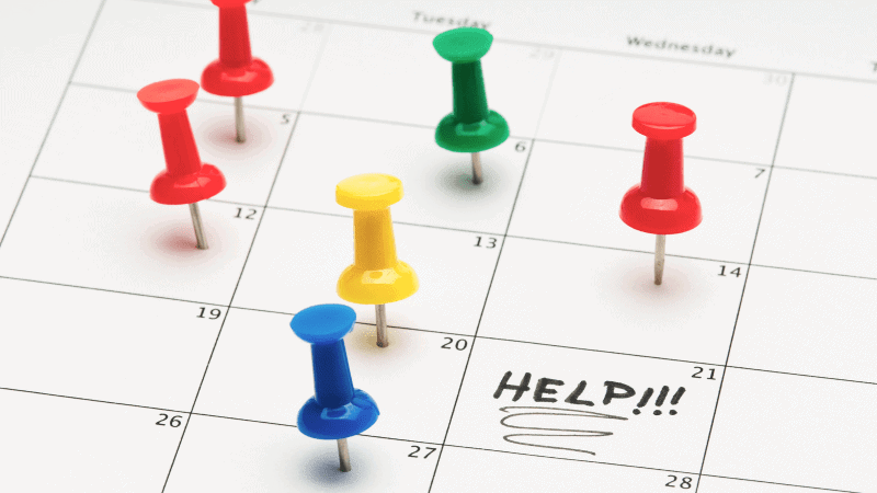 A calendar with thumbtacks on it