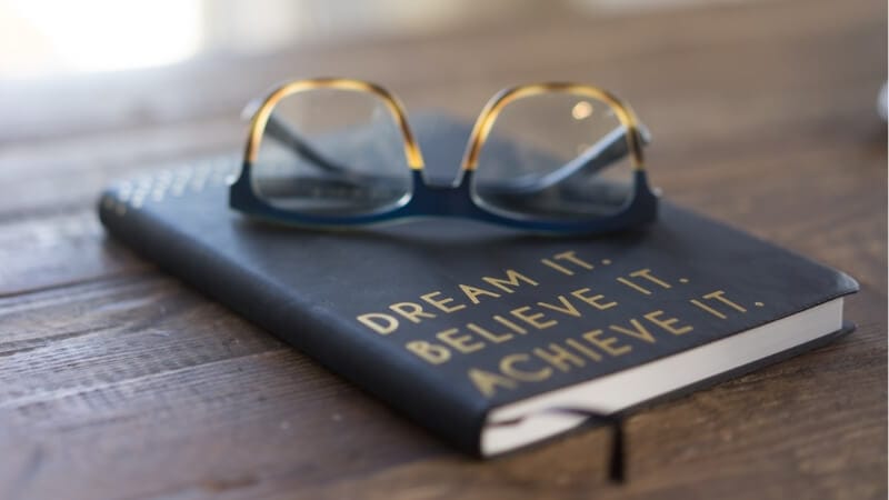 Black and brown eyeglasses on a book