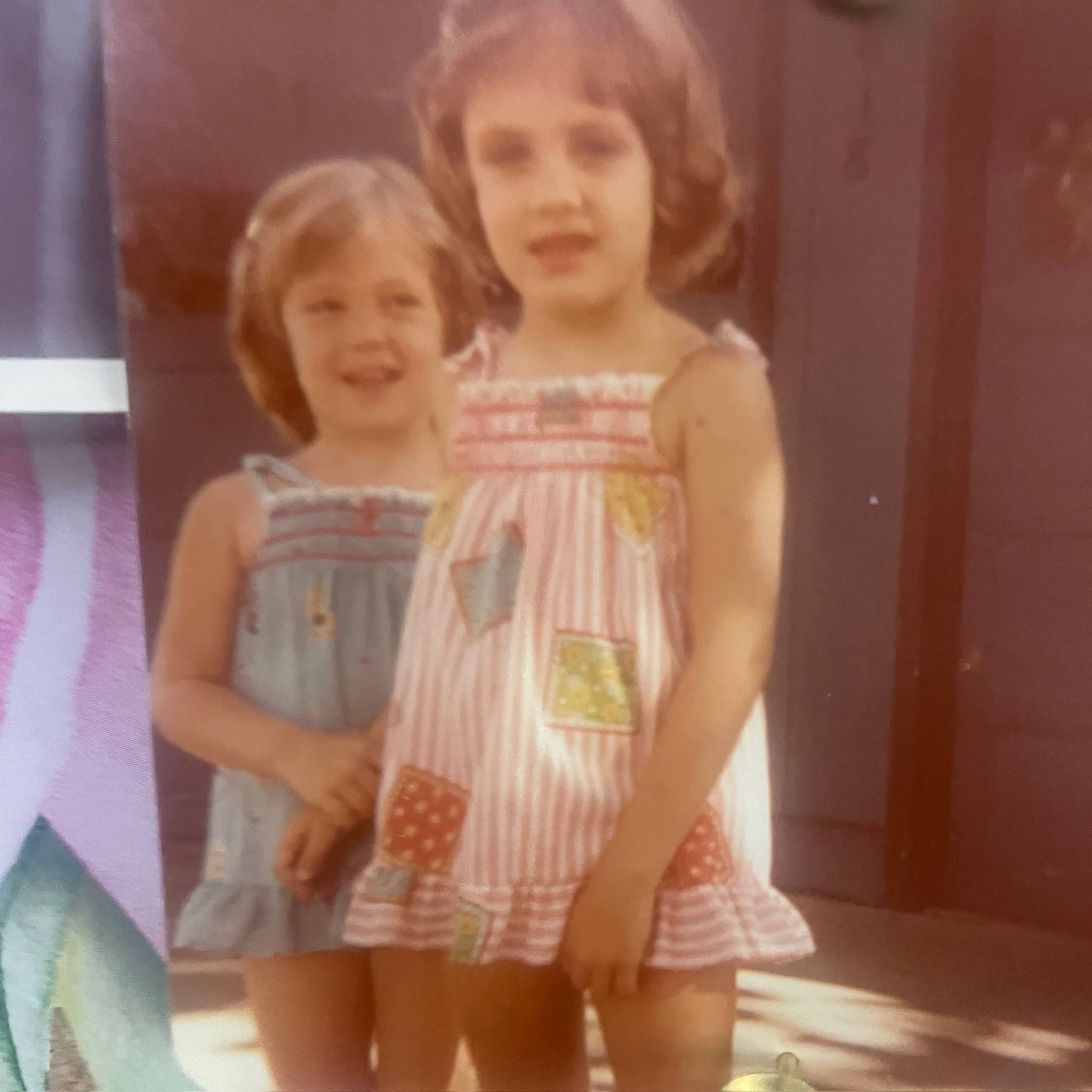 Christy and Kathy as young girls in matching sundresses