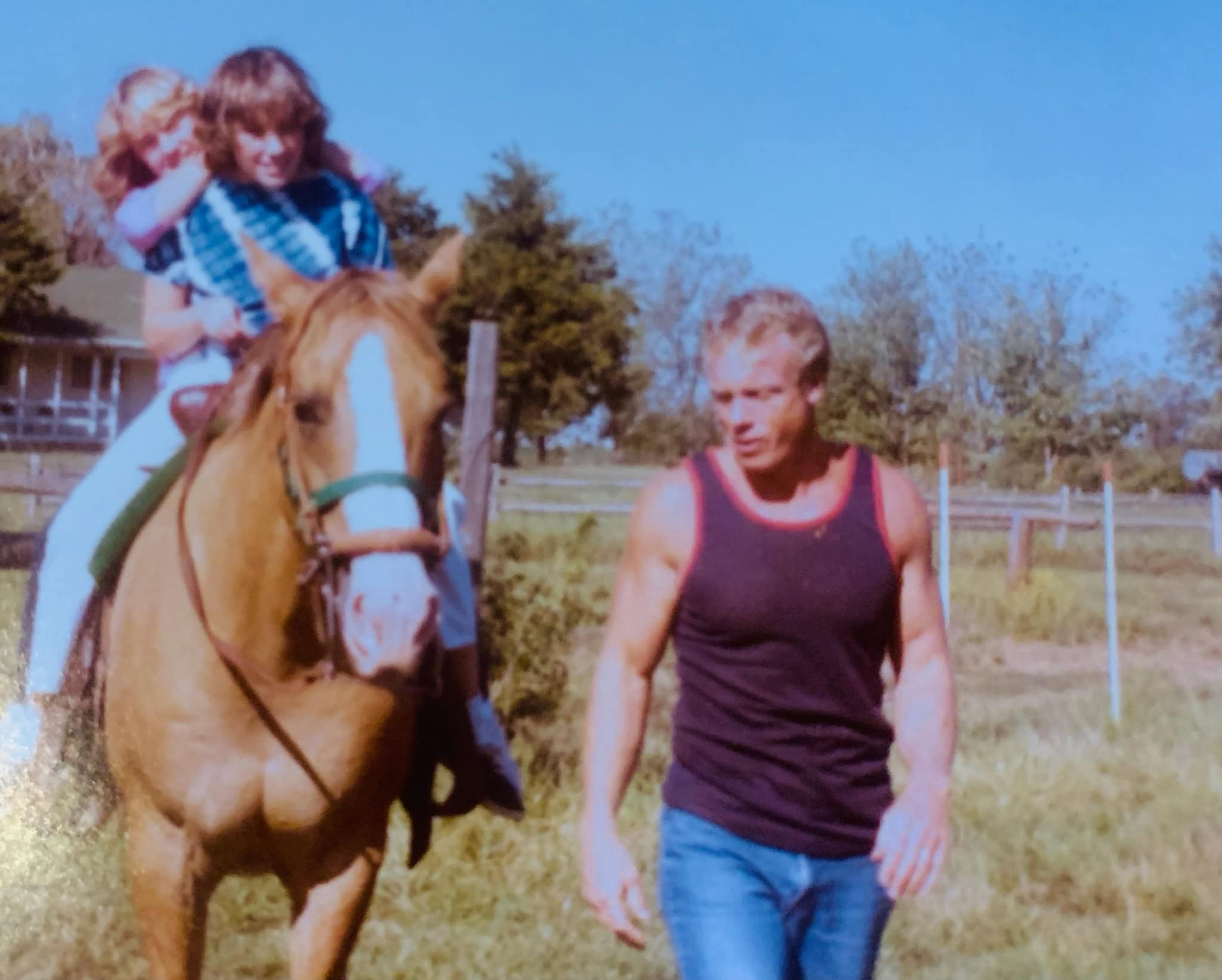 Christy on horseback with her dad walking alongside