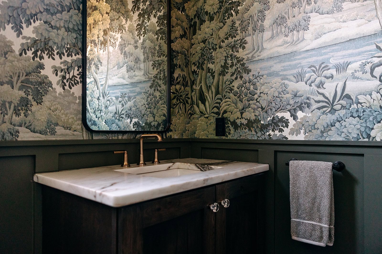 Powder room with scenic wallpaper and a stone sink