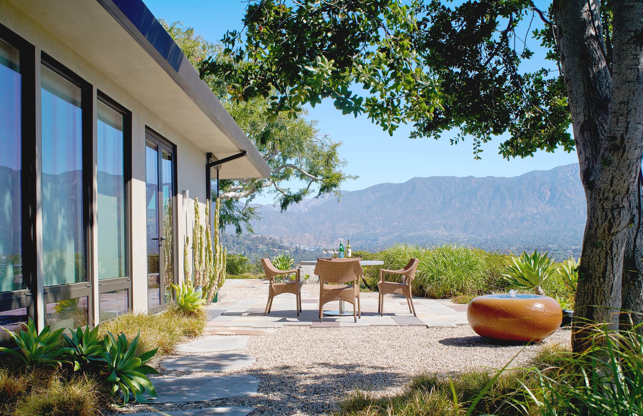 Mid-century home with a stone terrace and mountain views