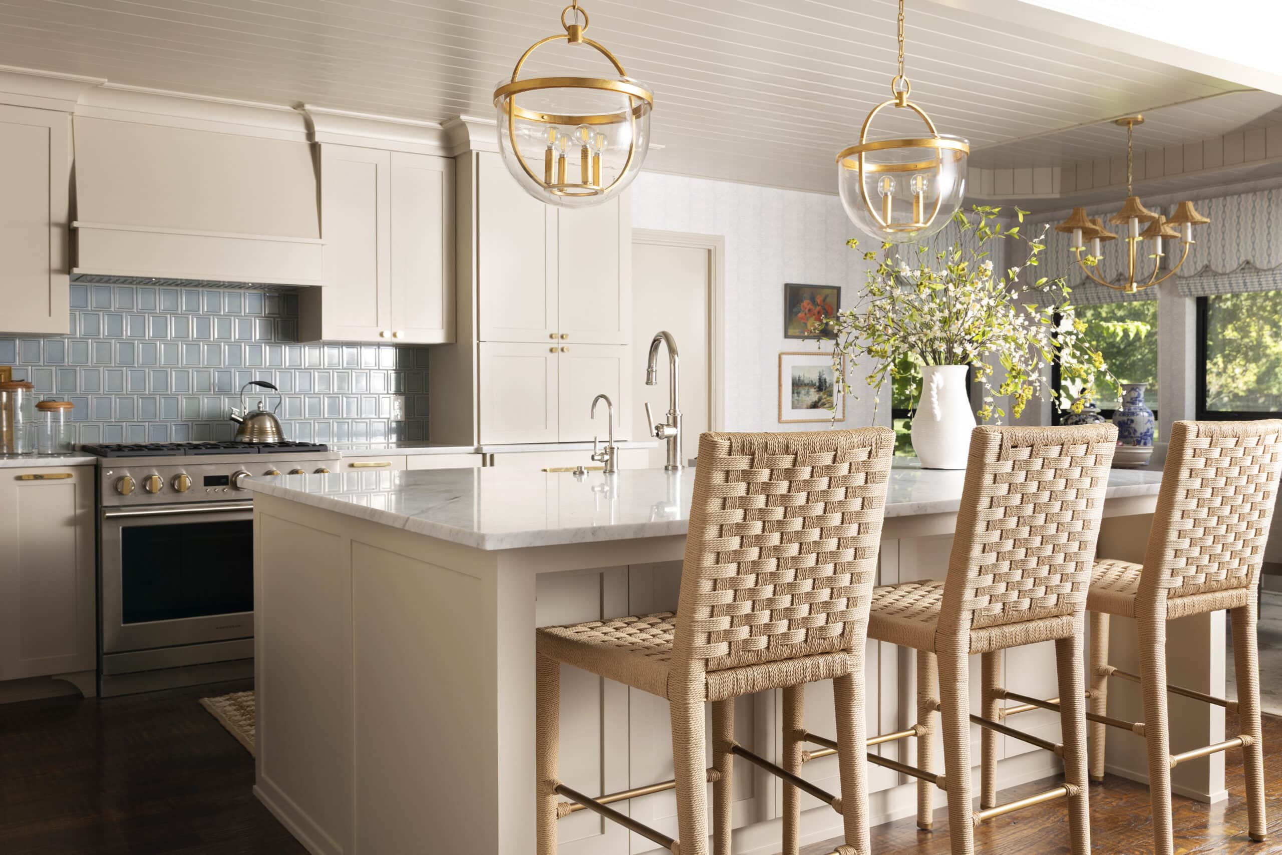 Kitchen with woven counter stools and blue tile