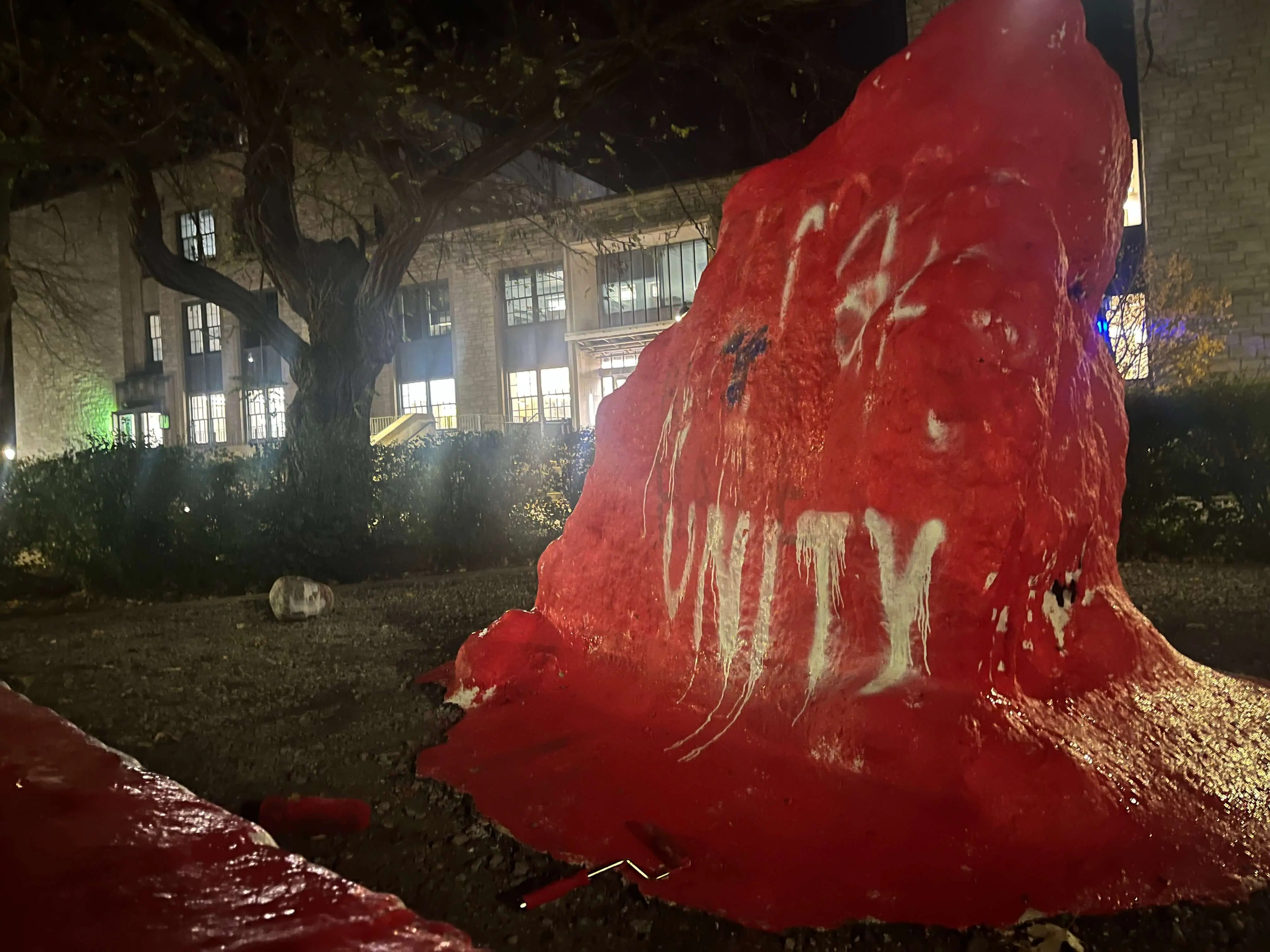 The Rock painted in red, with the phrase "Unity" written on it below a partially covered-up "MAGA"