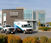 Image captures the Stinson corporate head office with two trucks in the foreground