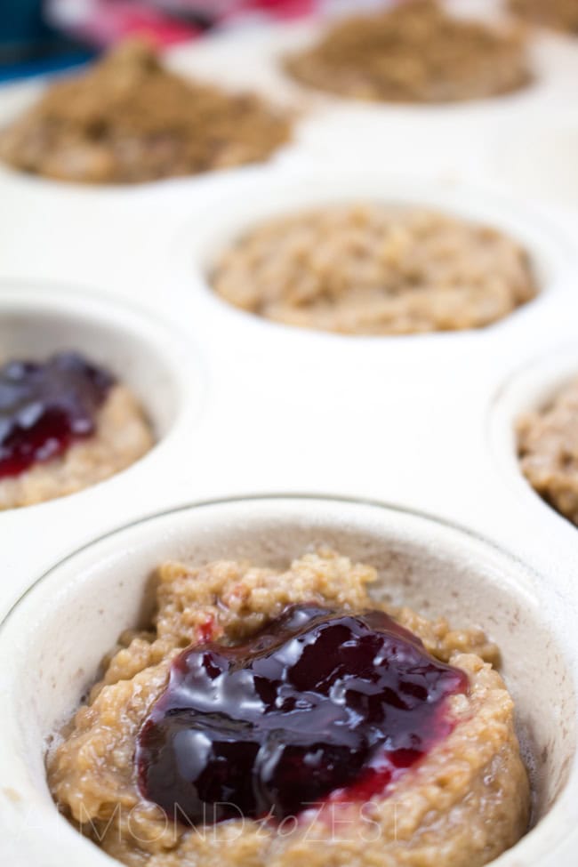 Whole-Wheat Jam Doughnut Muffins - A perfect way to start your morning these healthy layered muffins are bursting with flavor! Vegetarian too!!