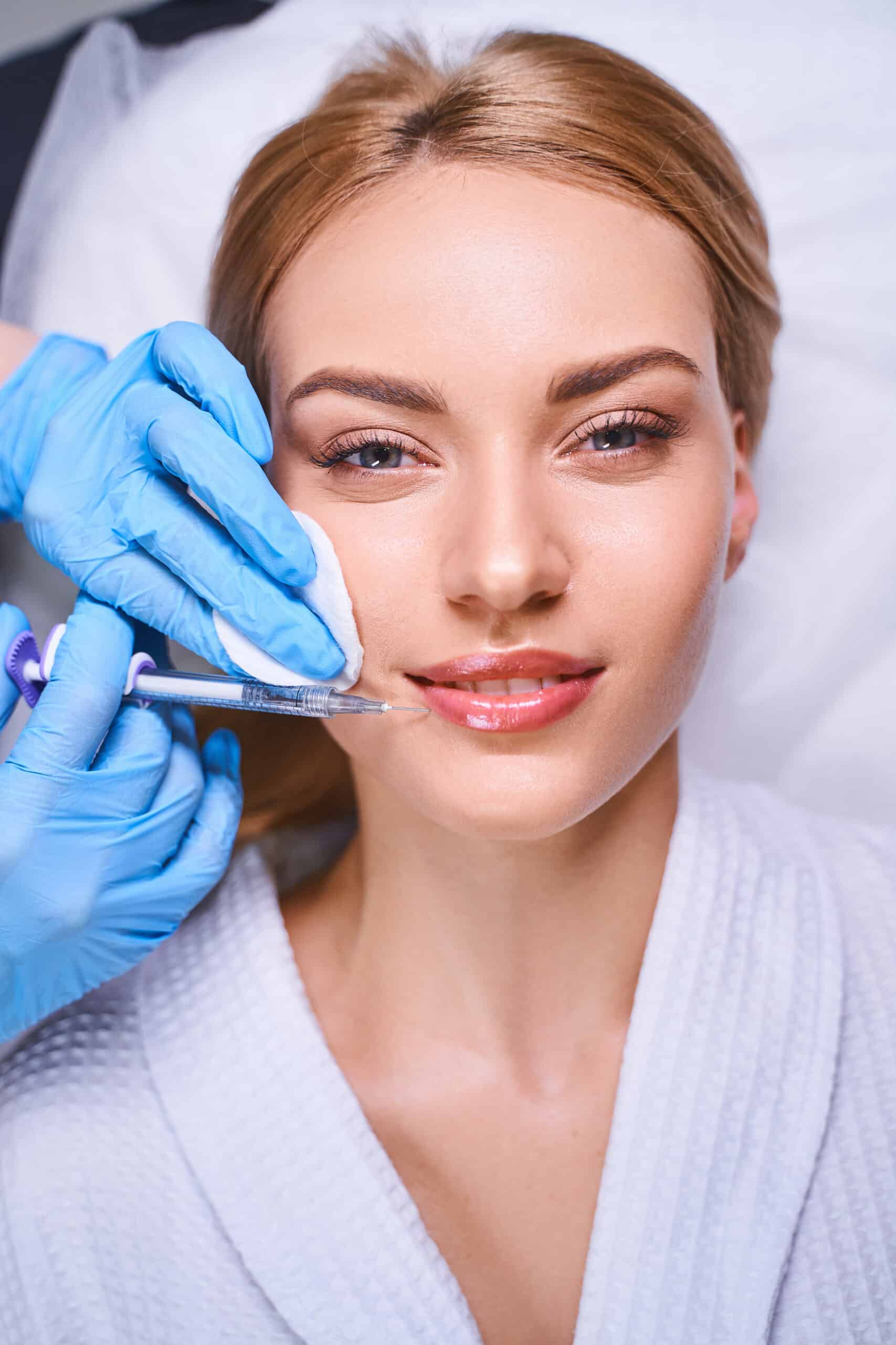 Happy woman during beauty injections stock photo