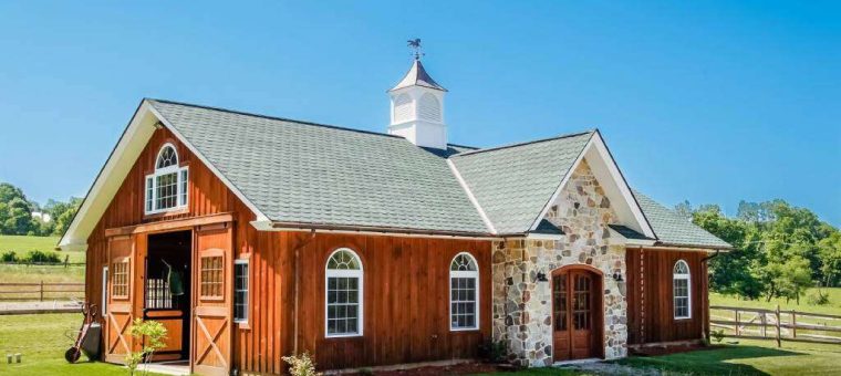 red barn structure with a new gray roof